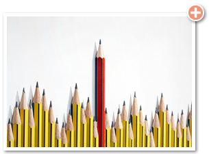 a grouping of small yellow pencils surrounding one large red pencil that stands out from the rest